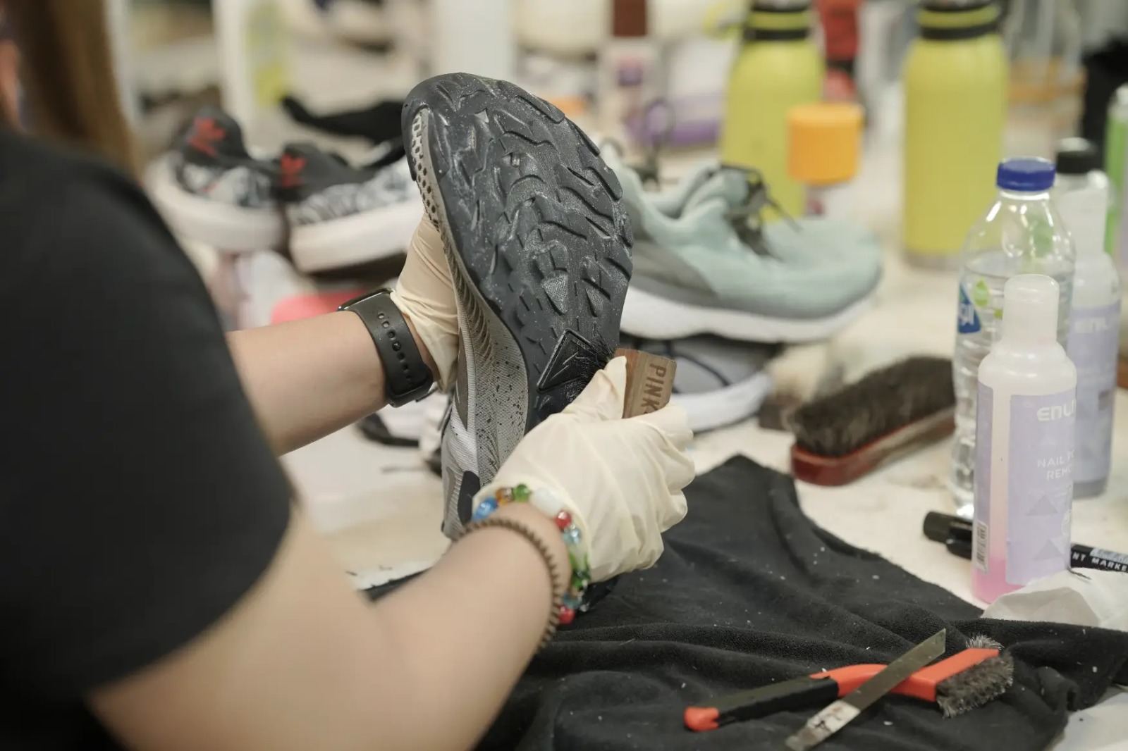 Technician restoring a sole at the repair bench